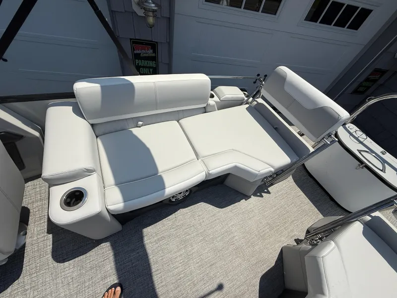 Slide: The Image of 2025 Avalon 2385 Catalina Quad Lounger with plush seating and cup holder on a sunny deck. - 25