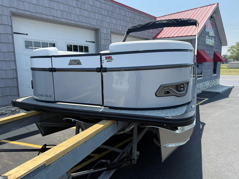 Slide: The Image of 2025 Avalon 2385 Catalina Quad Lounger Tri Toon on trailer, outside a building. - 4