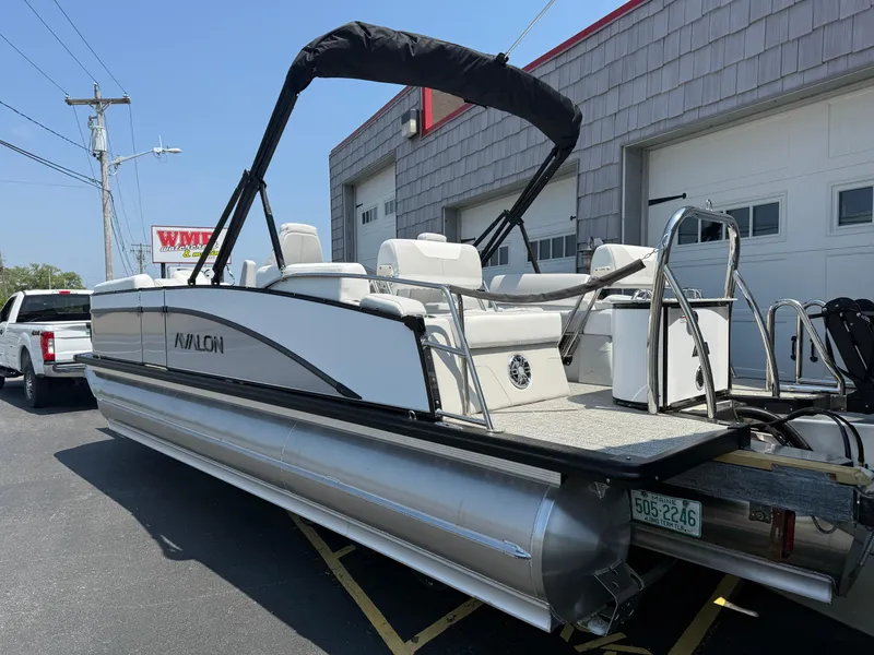 Slide: The Image of 2025 Avalon 2385 Catalina Quad Lounger Tri Toon boat parked outside a garage. - 5