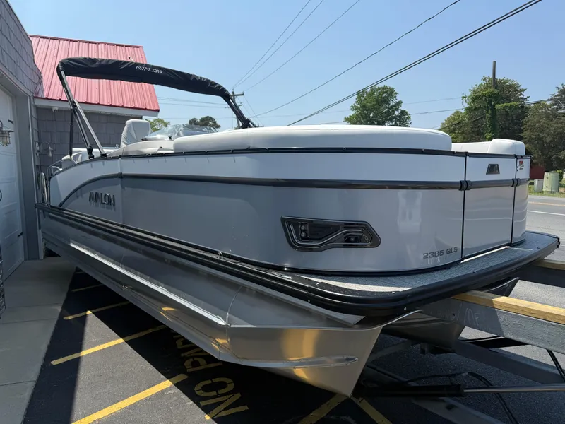Slide: The Image of 2025 Avalon 2385 Catalina Quad Lounger Tri Toon boat, parked outdoors, showcasing sleek design. - 8
