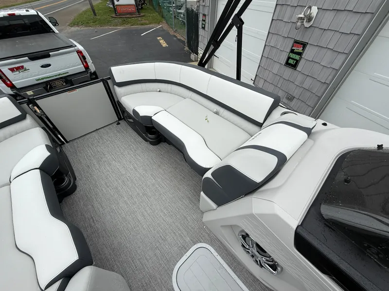 Slide: The Image of 2025 Avalon 2385 Catalina Quad Lounger interior with white and black seating. - 13