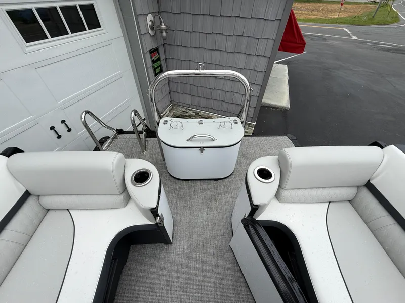 Slide: The Image of 2025 Avalon 2385 Catalina Quad Lounger interior with white seating and built-in cup holders. - 23