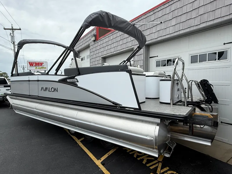 Slide: The Image of 2025 Avalon 2385 Catalina Quad Lounger Tri Toon, high-performance pontoon boat, parked outside a garage. - 5