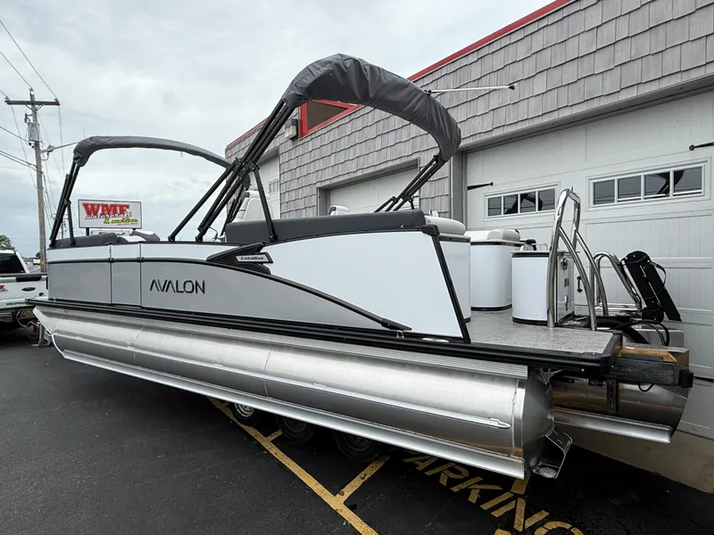 Slide: The Image of 2025 Avalon 2385 Catalina Quad Lounger, Tri Toon High Performance boat, parked outside a building. - 6