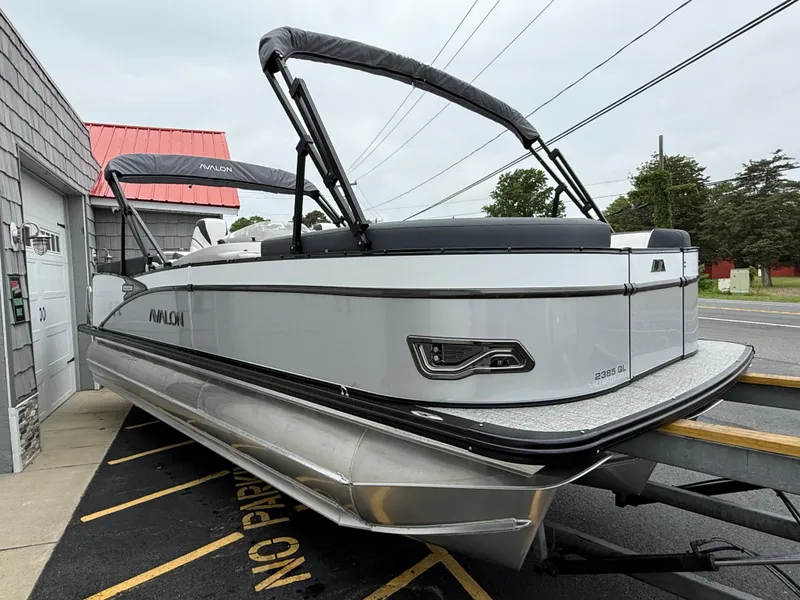 Slide: The Image of 2025 Avalon 2385 Catalina Quad Lounger Tri Toon, parked on trailer, side view. - 7