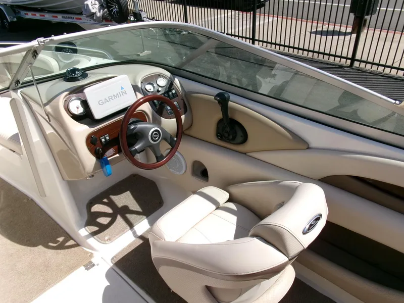 Slide: The Image of 2007 Chaparral 210 SSi boat interior with Garmin navigation system and beige seating. - 12
