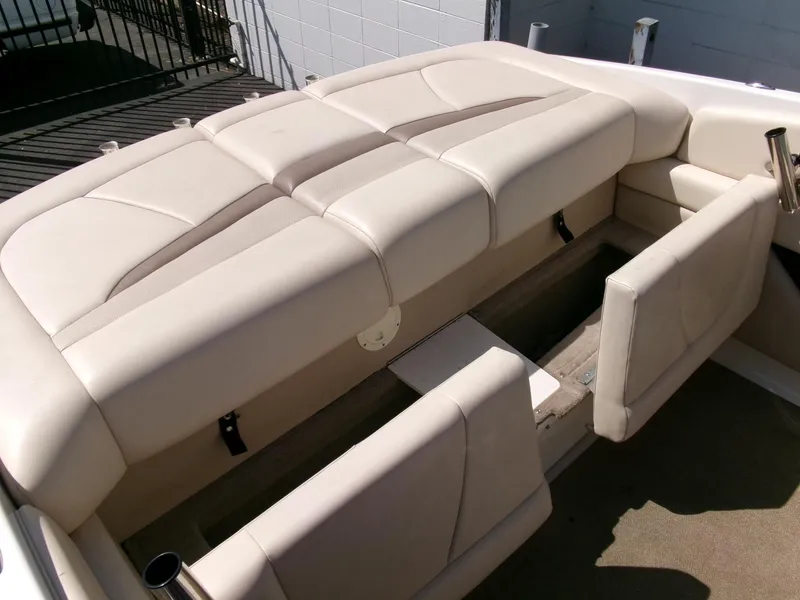 Slide: The Image of 2007 Chaparral 210 SSi boat interior with beige seating and storage compartments. - 22