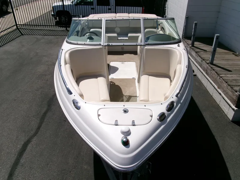 Slide: The Image of 2007 Chaparral 210 SSi boat with white interior, docked on pavement. - 30