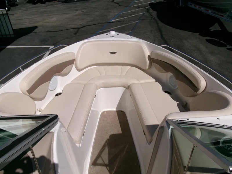 Slide: The Image of 2007 Chaparral 210 SSi boat interior with beige seating and open bow design. - 6