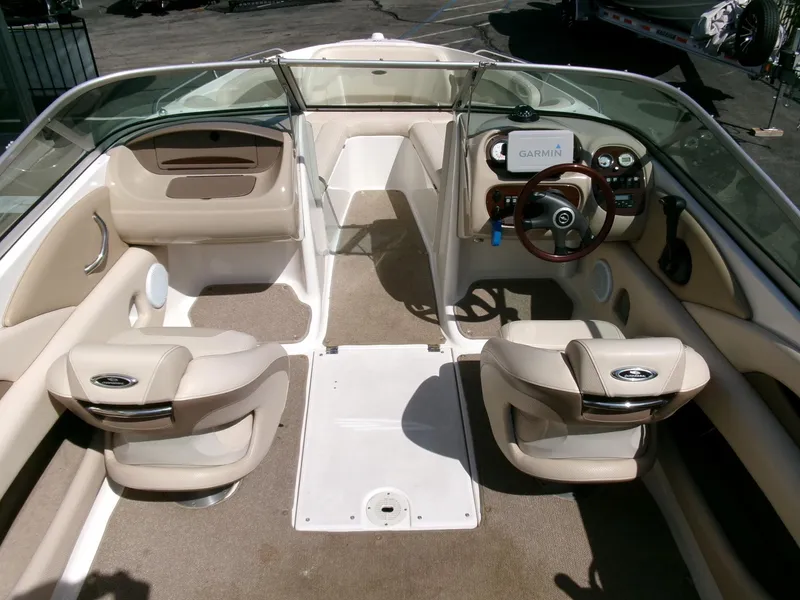 Slide: The Image of 2007 Chaparral 210 SSi boat interior with beige seating and Garmin navigation system. - 9