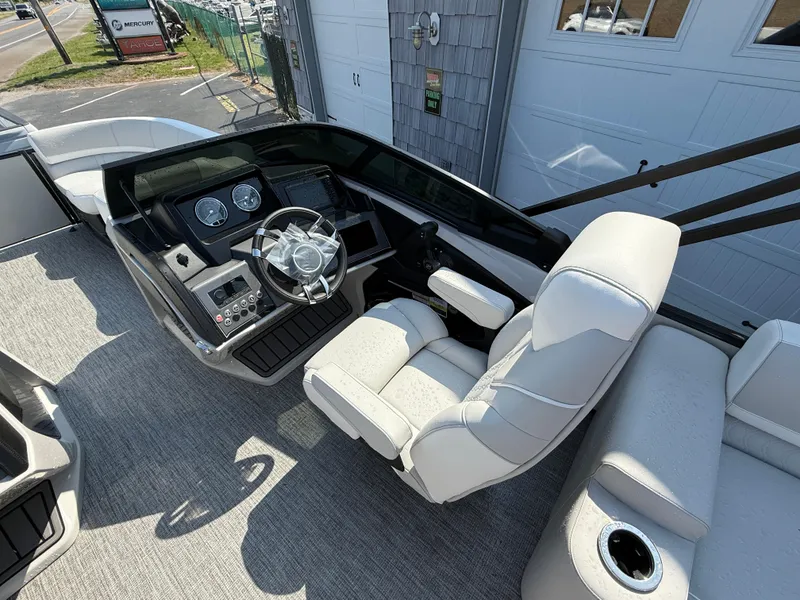 Slide: The Image of 2025 Avalon Catalina Quad Lounger Shift Windshield boat interior with modern helm and seating. - 11