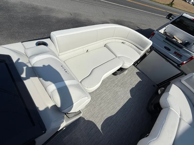 Slide: The Image of 2025 Avalon Catalina Quad Lounger with Shift Windshield, featuring spacious white seating. - 14