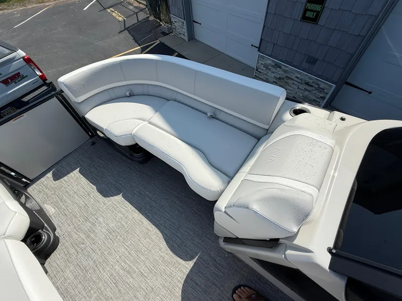Slide: The Image of 2025 Avalon Catalina Quad Lounger Shift Windshield boat interior with white seating. - 15
