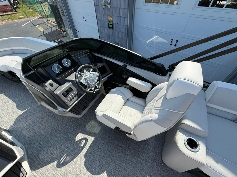 Slide: The Image of 2025 Avalon Catalina Quad Lounger Shift Windshield boat interior with modern helm and seating. - 21