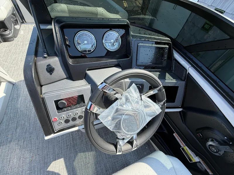 Slide: The Image of 2025 Avalon Catalina Quad Lounger dashboard with steering wheel and instrument panel. - 23