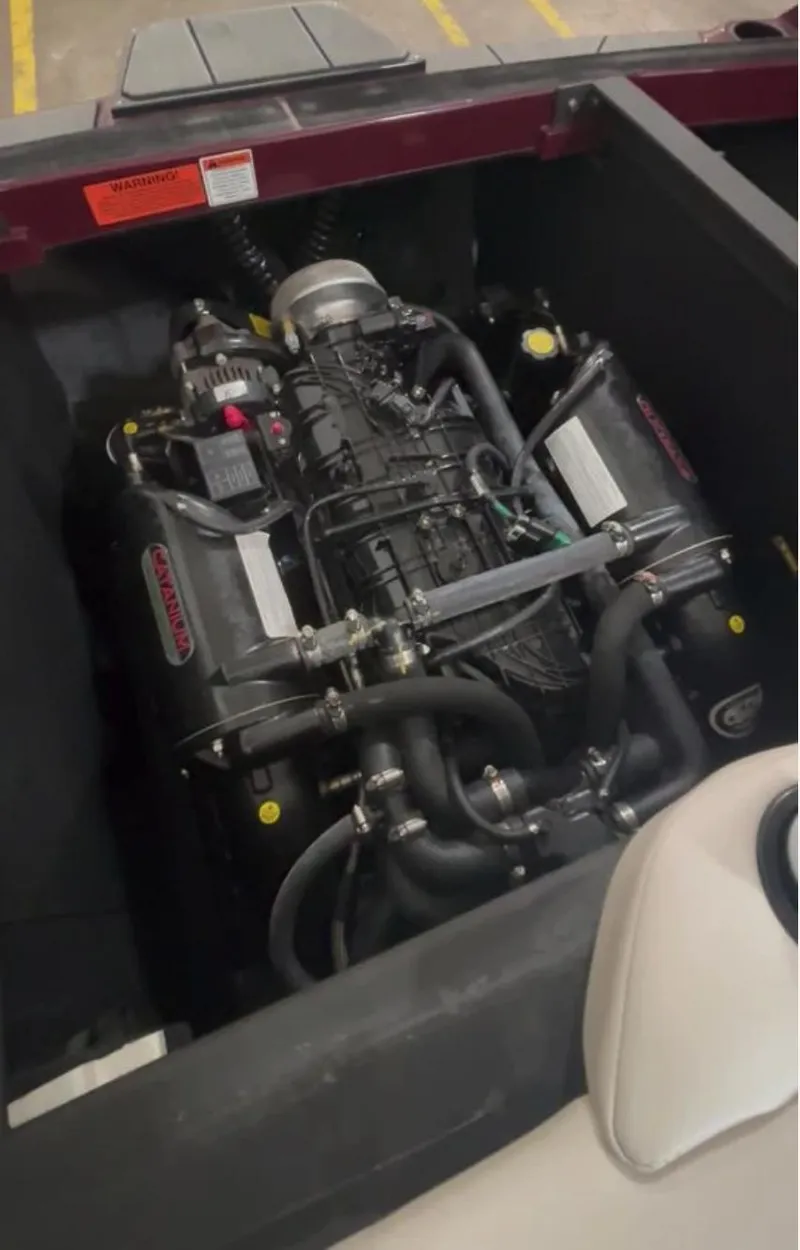 Slide: The Image of Engine compartment of a 2018 Axis T 22 boat, showcasing detailed mechanical components. - 12