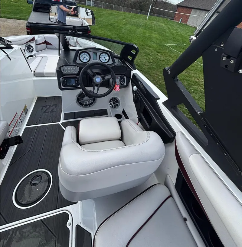 Slide: The Image of 2018 Axis T 22 boat interior with modern dashboard and plush seating. - 6
