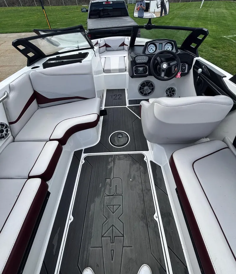 Slide: The Image of 2018 Axis T 22 boat interior with sleek seating and modern dashboard design. - 7