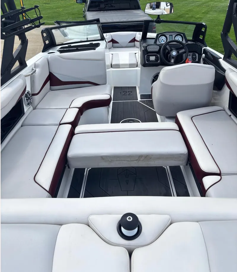 Slide: The Image of 2018 Axis T 22 boat interior with white seating and modern dashboard. - 9