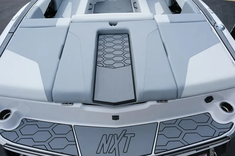 Slide: The Image of 2025 MasterCraft NXT24 boat with sleek gray seating and hexagonal design accents. - 15