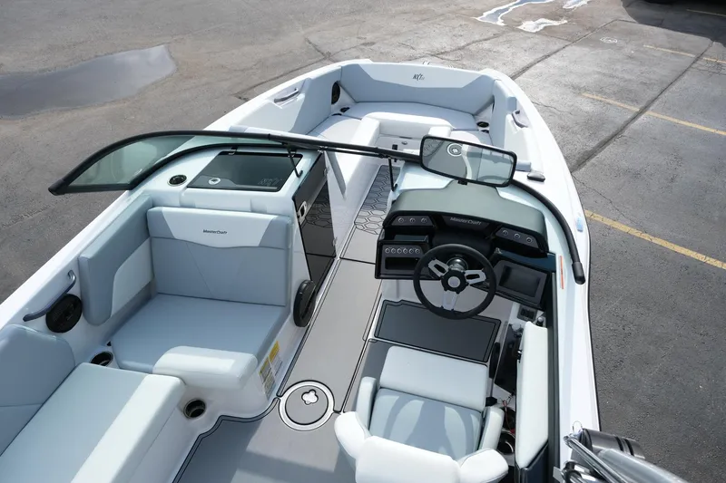Slide: The Image of 2025 MasterCraft NXT24 boat interior with modern seating and dashboard design. - 16