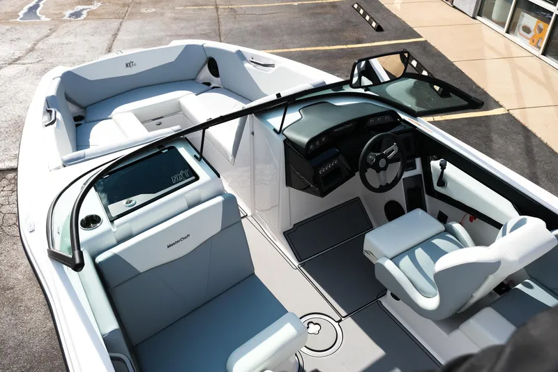 Slide: The Image of 2025 MasterCraft NXT24 boat interior with sleek design and modern seating arrangement. - 17