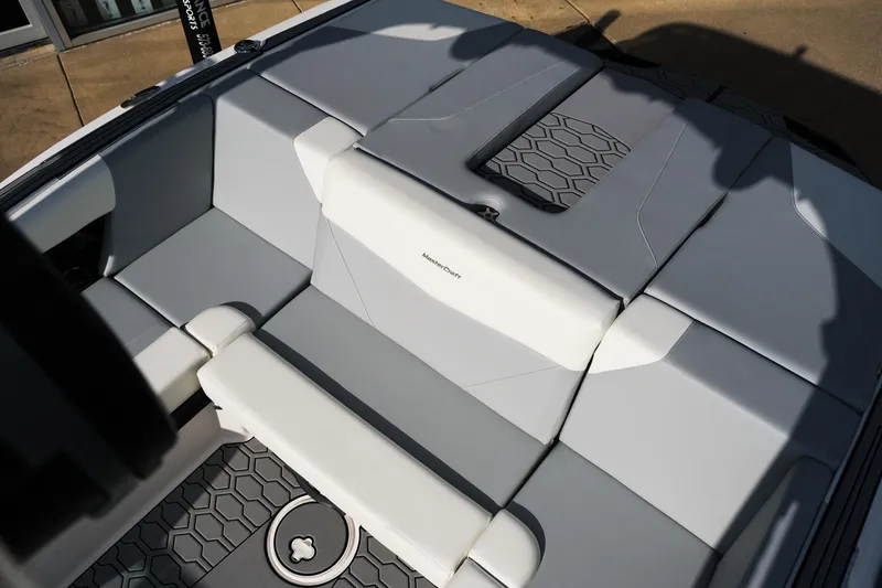 Slide: The Image of 2025 MasterCraft NXT24 boat interior with gray and white seating. - 18
