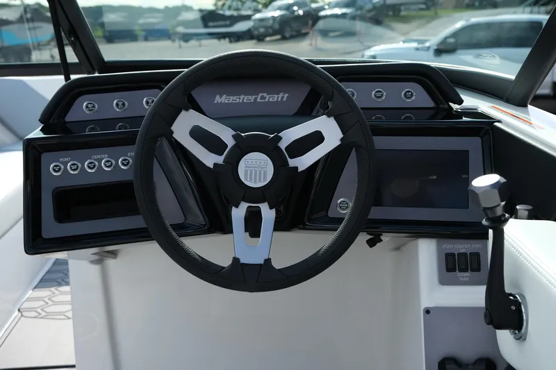 Slide: The Image of 2025 MasterCraft NXT24 boat dashboard with steering wheel and control panel. - 20