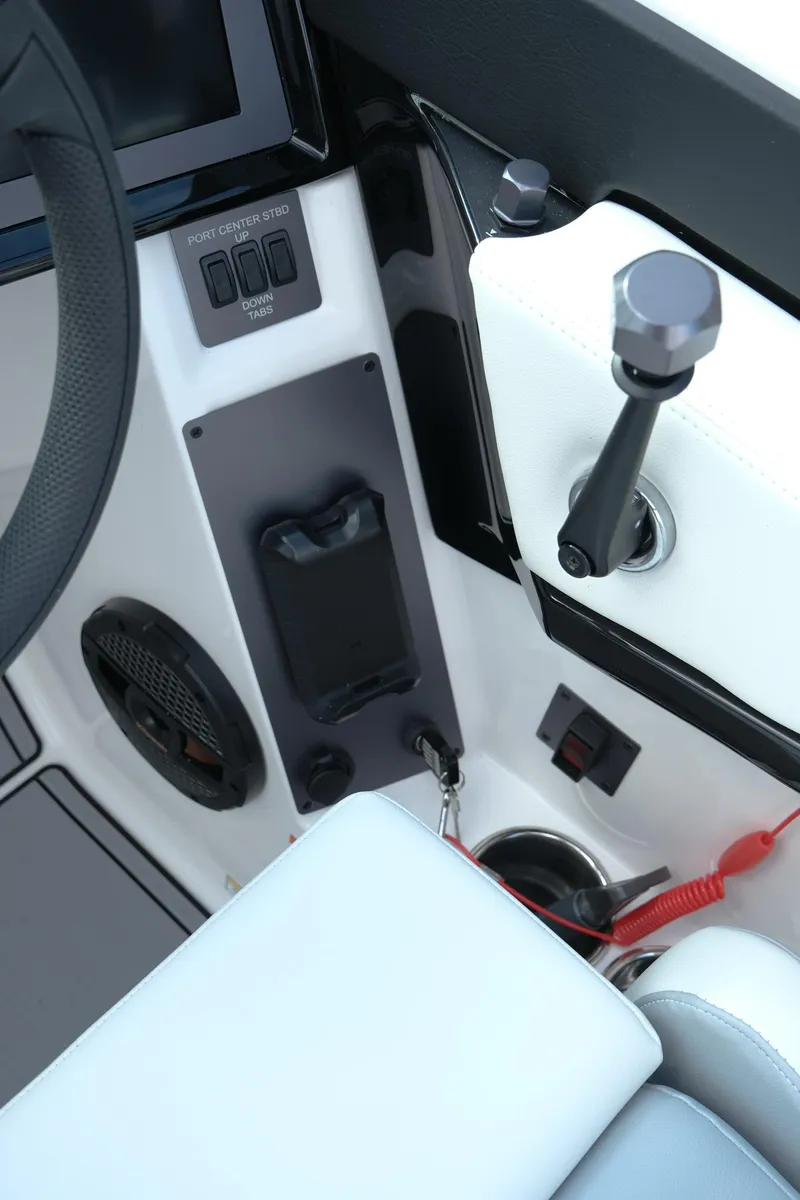 Slide: The Image of 2025 MasterCraft NXT24 boat cockpit with control panel and throttle lever. - 21