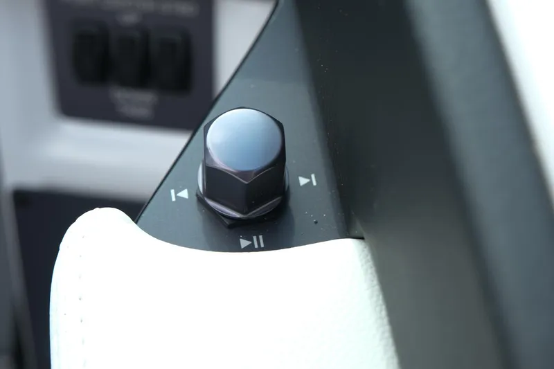 Slide: The Image of Control knob on 2025 MasterCraft NXT24 boat dashboard, featuring playback buttons. - 22