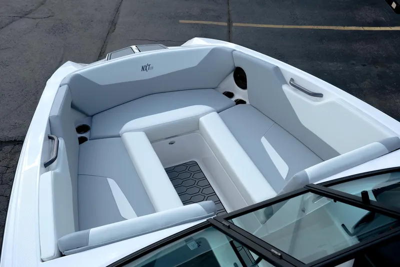 Slide: The Image of 2025 MasterCraft NXT24 boat interior with white seating and modern design. - 23