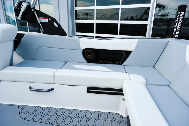 Slide: The Image of 2025 MasterCraft NXT24 boat interior with sleek white seating and modern design. - 26