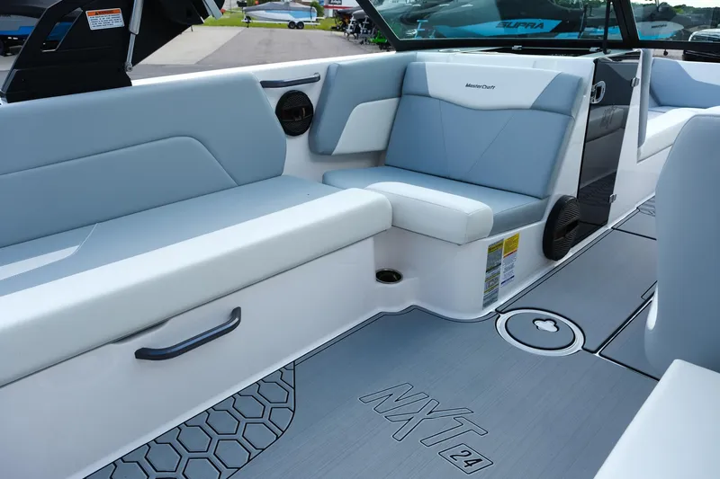 Slide: The Image of 2025 MasterCraft NXT24 boat interior with sleek seating and modern design. - 28
