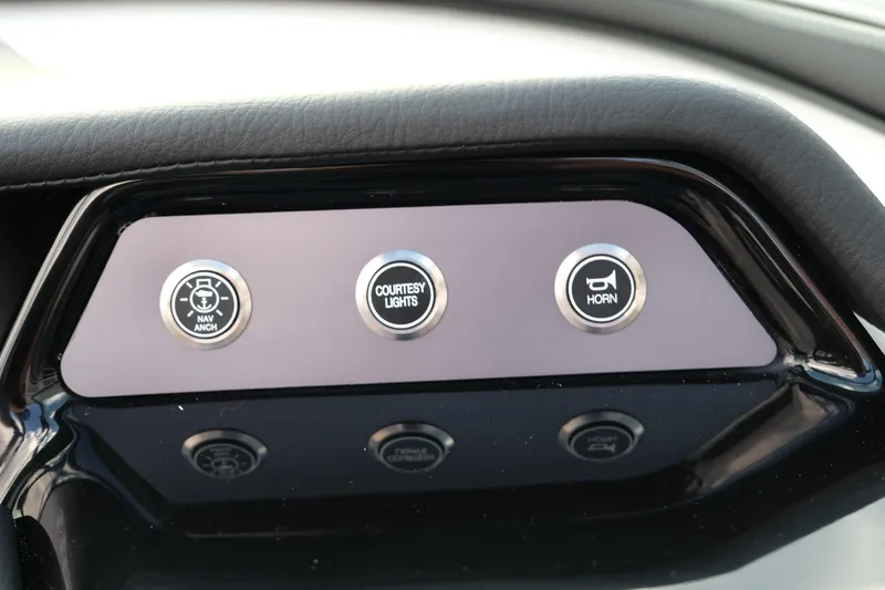 Slide: The Image of Control panel of 2025 MasterCraft NXT24 boat with buttons for anchor, lights, and horn. - 31