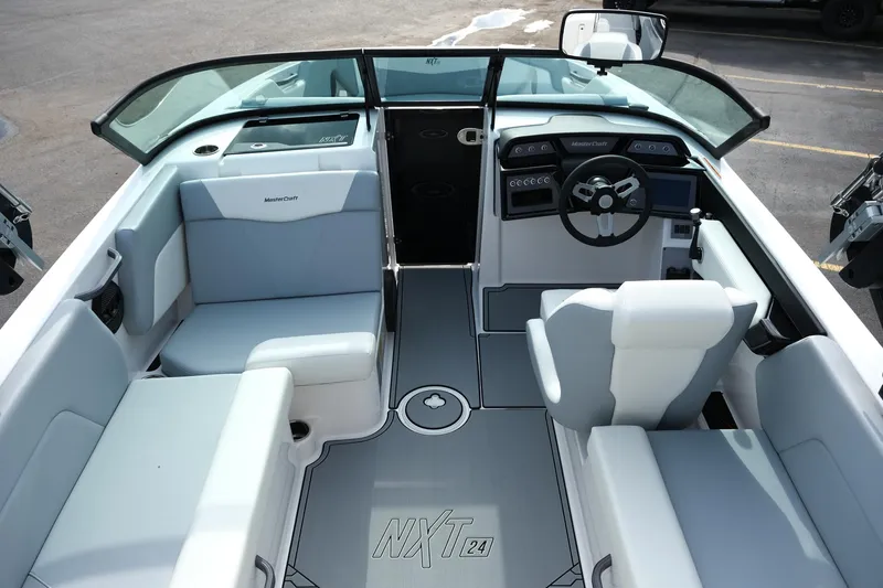 Slide: The Image of 2025 MasterCraft NXT24 boat interior with modern seating and steering wheel. - 41