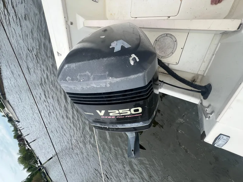 Slide: The Image of 1989 Mako 250 Cuddy Cabin with Yamaha V250 outboard motor on water. - 11