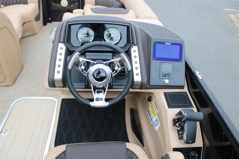 Slide: The Image of 2025 Barletta Lusso 23U boat dashboard with steering wheel and digital display. - 12