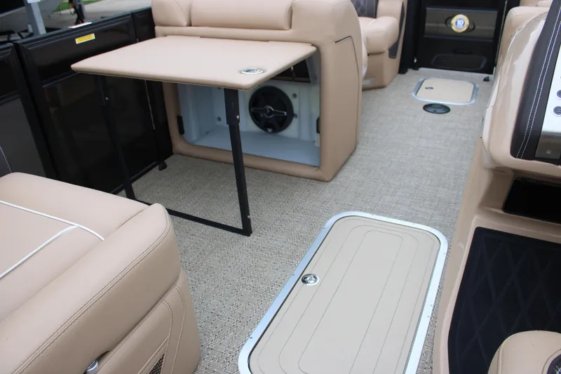 Slide: The Image of 2025 Barletta Lusso 23U interior with beige seating and foldable table. - 13