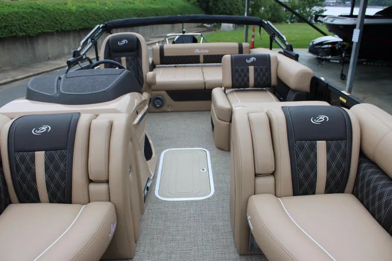 Slide: The Image of 2025 Barletta Lusso 23U pontoon boat interior with luxurious tan seating and modern design. - 18