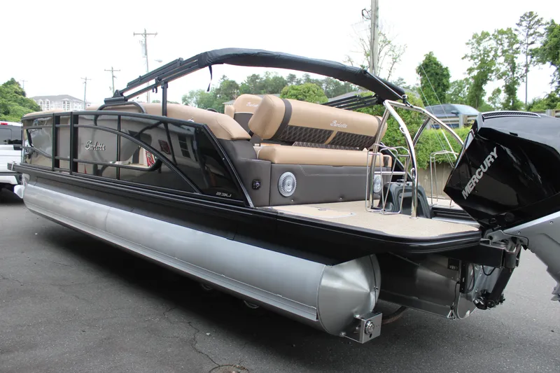 Slide: The Image of 2025 Barletta Lusso 23U pontoon boat with Mercury engine, sleek design, and luxurious seating. - 5