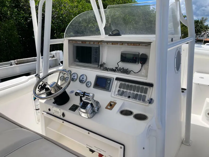 Slide: The Image of 2007 Marlago 35 boat console with steering wheel, gauges, and navigation equipment. - 14