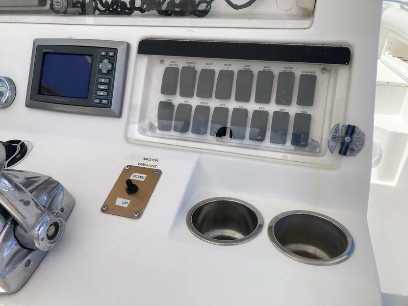 Slide: The Image of Control panel of a 2007 Marlago 35 boat with switches and display screen. - 15