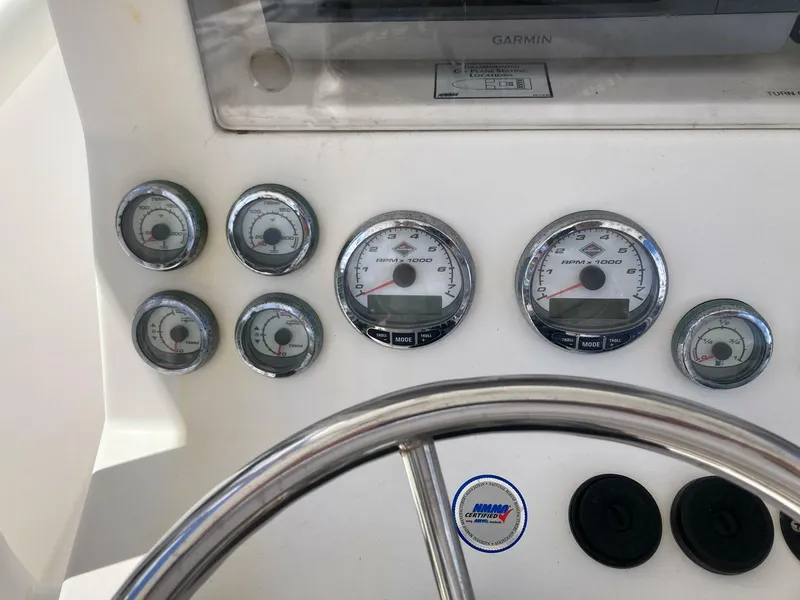 Slide: The Image of Dashboard of a 2007 Marlago 35 boat with gauges and steering wheel. - 17