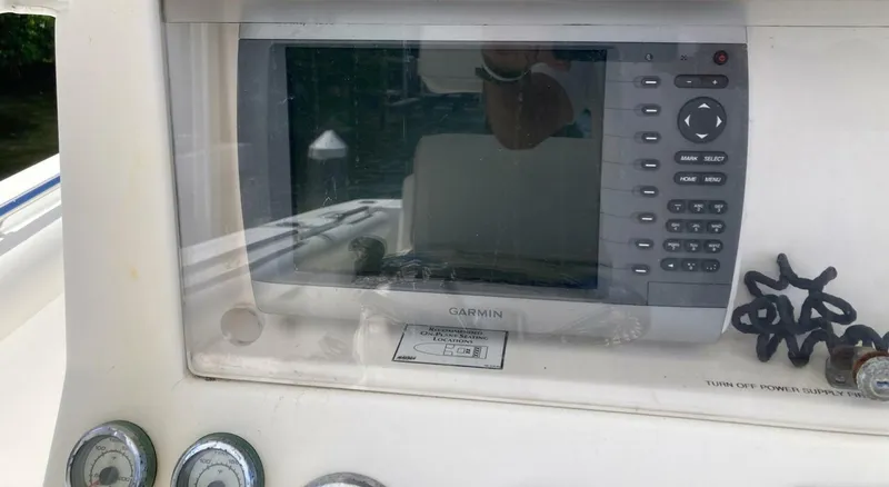 Slide: The Image of Control panel of a 2007 Marlago 35 boat featuring a Garmin navigation system. - 18