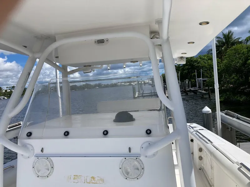 Slide: The Image of 2007 Marlago 35 boat with white console, docked near lush greenery and calm waters. - 22