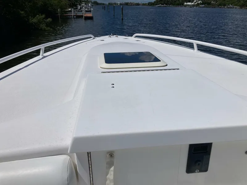Slide: The Image of 2007 Marlago 35 boat deck with hatch, cruising on a calm river. - 23
