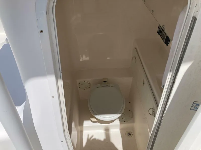 Slide: The Image of 2007 Marlago 35 boat interior bathroom with toilet and storage compartments. - 25