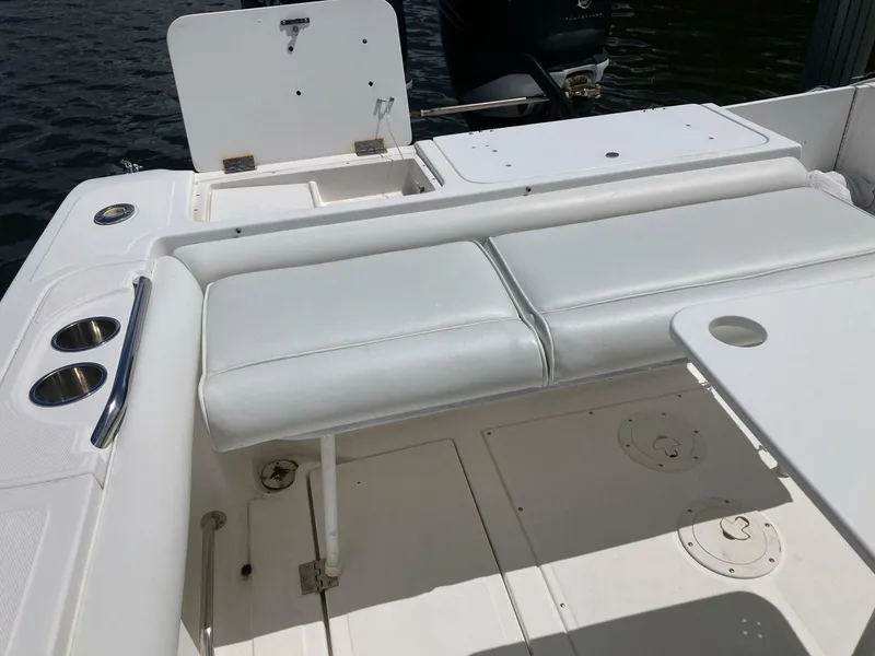 Slide: The Image of 2007 Marlago 35 boat interior with white seating and cup holders. - 27