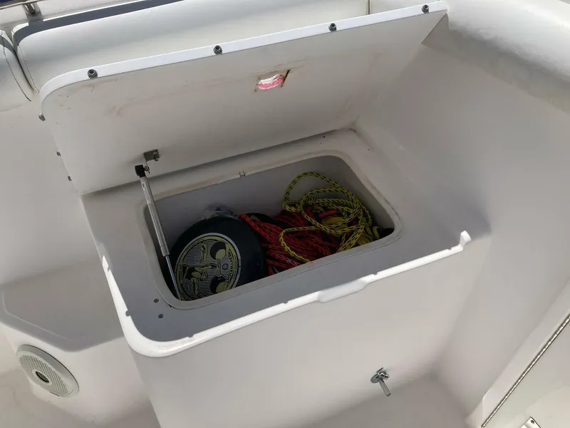 Slide: The Image of Open storage compartment on a 2007 Marlago 35 boat, containing ropes and equipment. - 29
