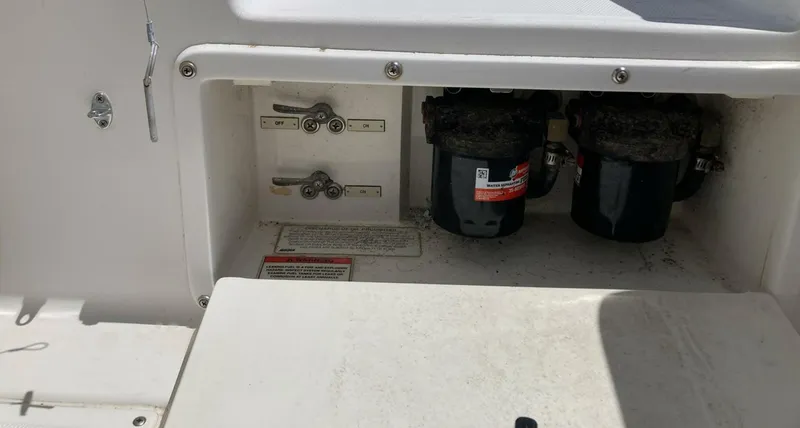 Slide: The Image of 2007 Marlago 35 boat compartment with filters and switches. - 31
